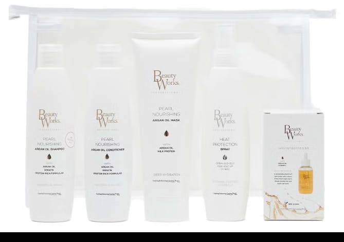 Beauty Works hair care set including shampoo, conditioner, mask, heat protection spray, and serum in a clear pouch.